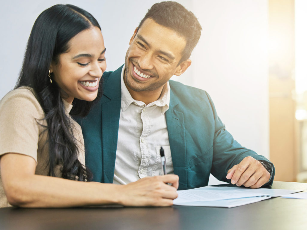 young couple signing estate plan