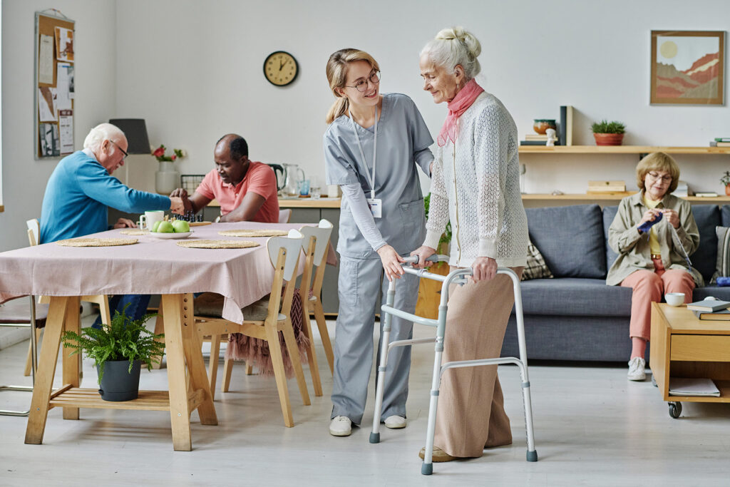 Elderly person getting assistance in a senior living home.